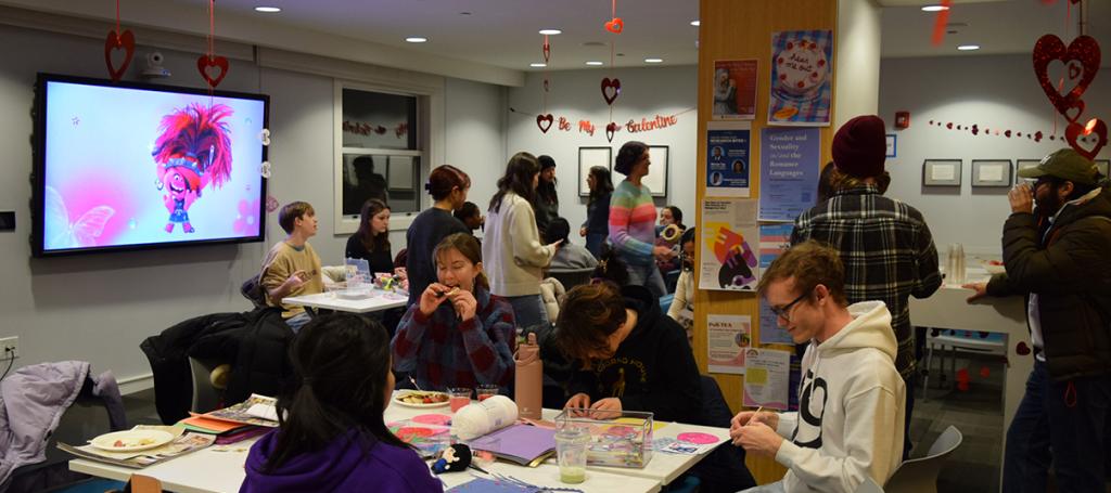 People seated and standing mingling with each other.